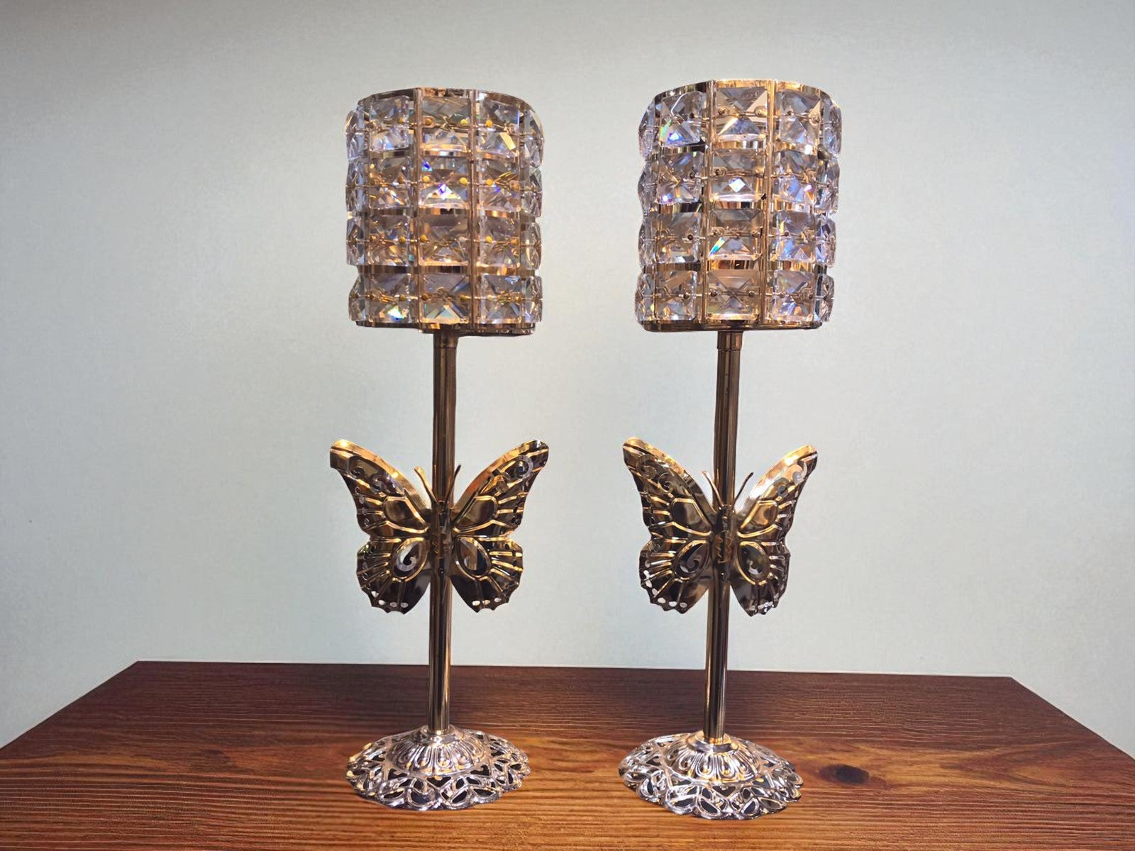 "Pair of Golden Butterfly and Crystal Pillar Candle Holders." complete set