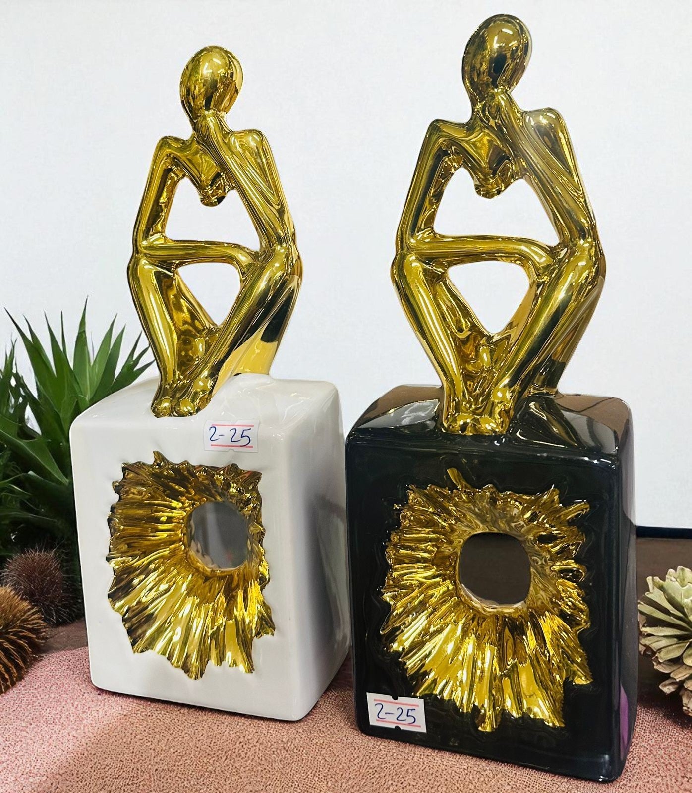 Golden Thinker Statues on Decorative bases